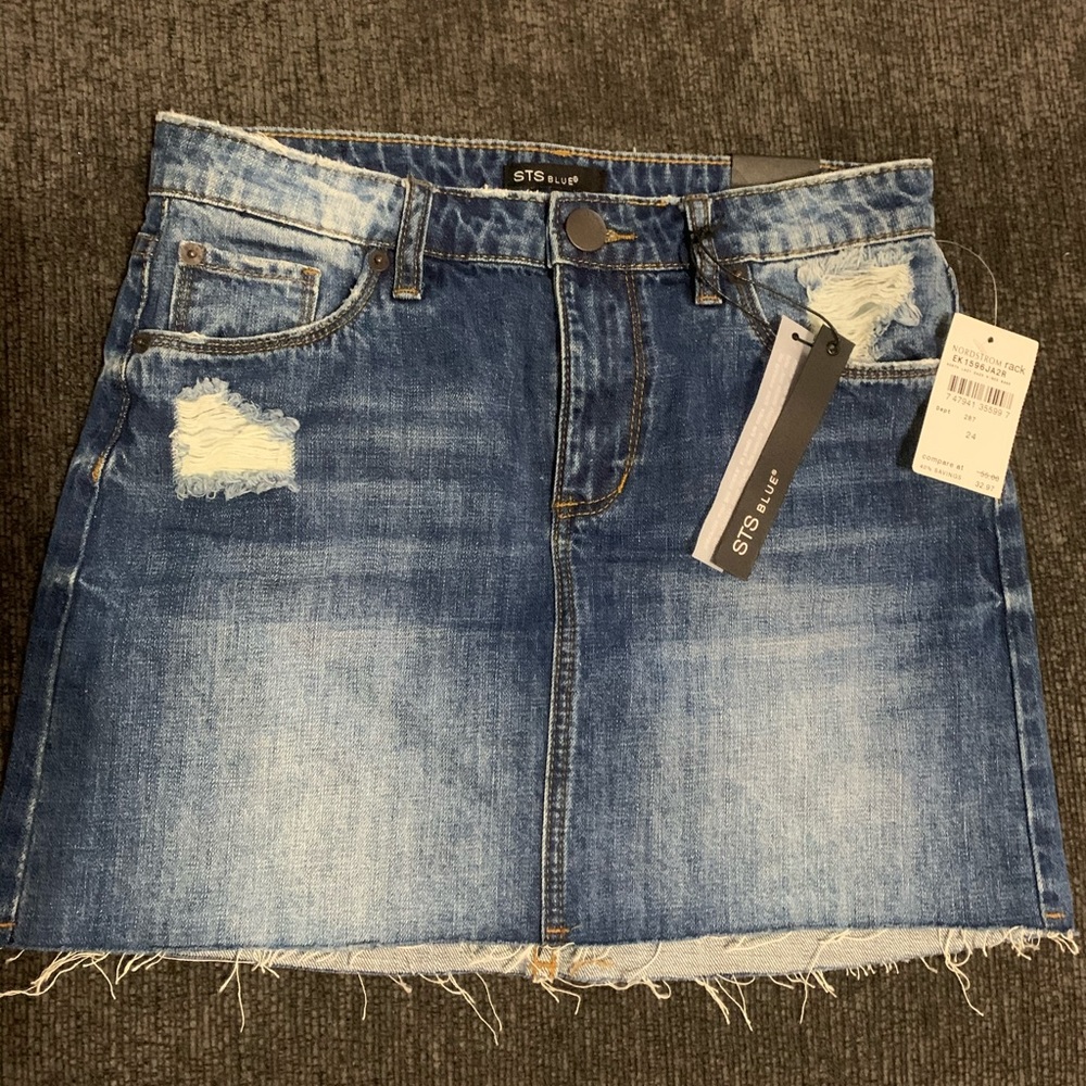 Woman’s distressed denim jean skirt